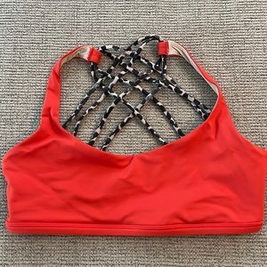 Lululemon orange sports bra with cheetah print straps